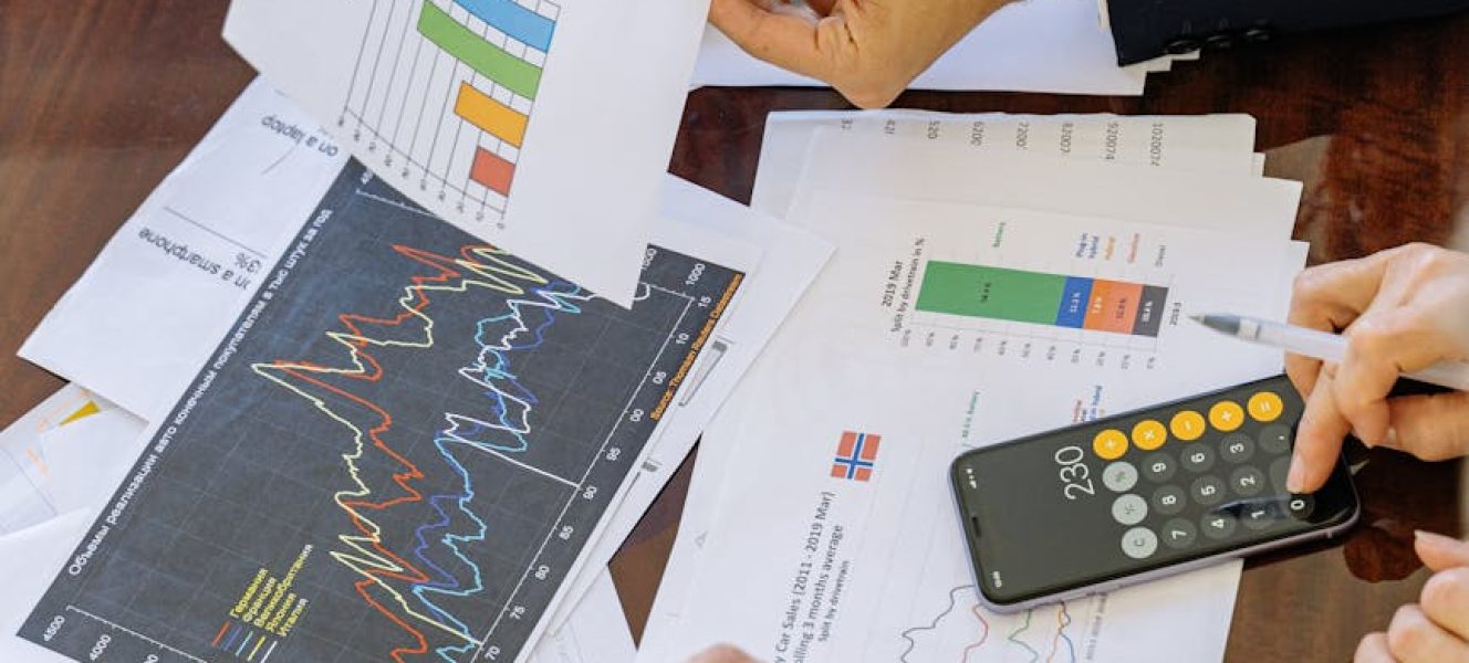 Business professionals analyzing financial charts and graphs during a meeting.